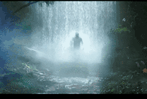 猛男拿着钢叉从瀑布中走出来GIF图片